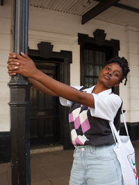 Side view of young woman standing at home