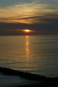 Scenic view of sea against romantic sky at sunset