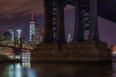 Low angle view of manhattan bridge and brooklyn bridge at night