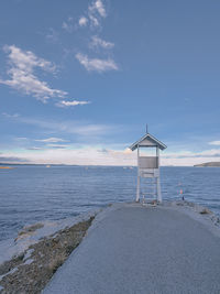 Lifeguard hut on beach against sky