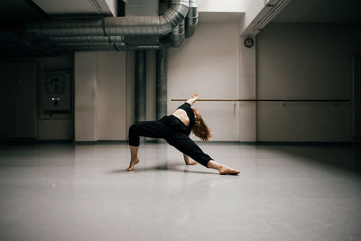 Full length of woman standing in corridor