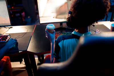 Rear view of woman sitting in cafe