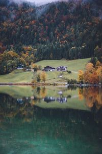 Scenic view of lake by autumn trees against sky