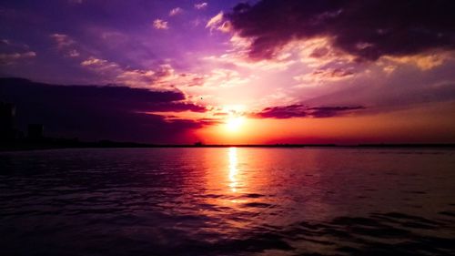 Scenic view of sea against romantic sky at sunset