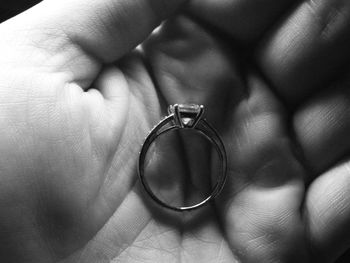 Close-up of hands holding wedding rings