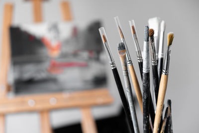 Close-up of paintbrushes in container