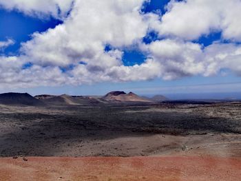 View of desert against cloudy sky