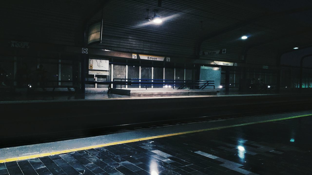 illuminated, rail transportation, architecture, railroad station, public transportation, transportation, railroad station platform, no people, built structure, indoors, night, mode of transportation, railroad track, track, reflection, lighting equipment, motion, travel, train, architectural column, ceiling, station, light