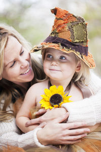 Portrait of happy girl holding hat