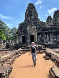 Rear view of woman standing outside temple