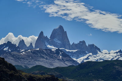 Scenic view of mountains against cloudy sky