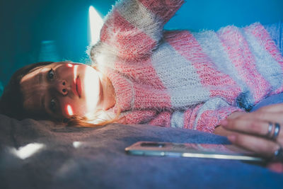 Close-up of girl using mobile phone at home