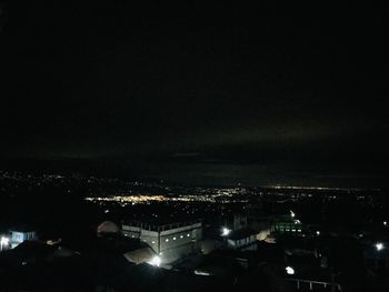 High angle view of illuminated buildings in city at night