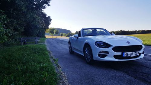 Vintage car on landscape against clear sky