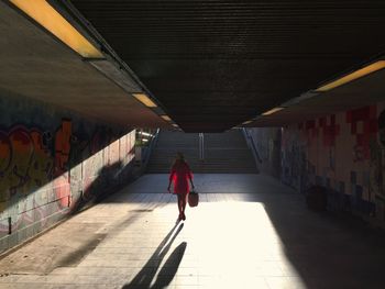 Woman walking in tunnel