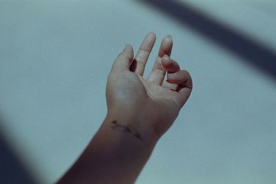 Close-up of hand on wall