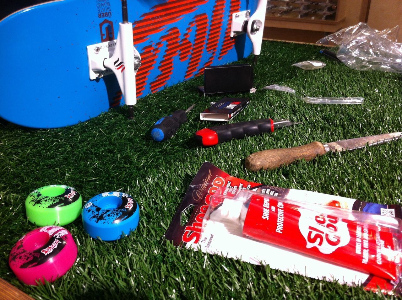 grass, field, variation, green color, multi colored, grassy, day, blue, outdoors, plastic, high angle view, no people, sunlight, absence, toy, still life, close-up, red, flag, large group of objects