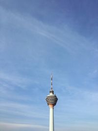 Low angle view of communications tower against blue sky