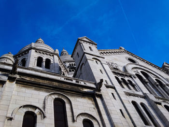 Low angle view of building against blue sky