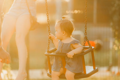 Boy swinging at playground