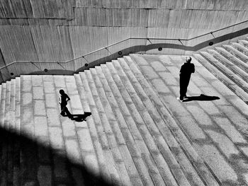  high angle view of silhouette of people on steps 