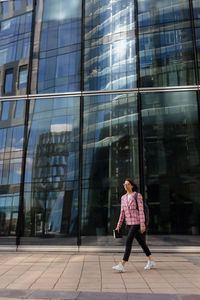 Rear view of woman walking on street