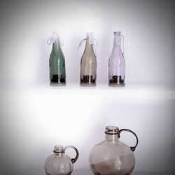 Close-up of glass jar on table against wall