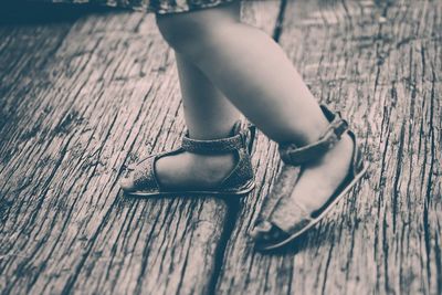 Close-up of shoes on wooden floor