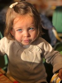 Portrait of cute girl sitting at home