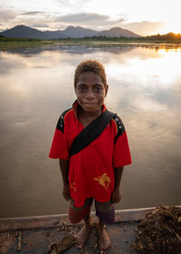 Portrait of smiling girl standing in lake