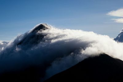 Scenic view of mountains against cloudy sky