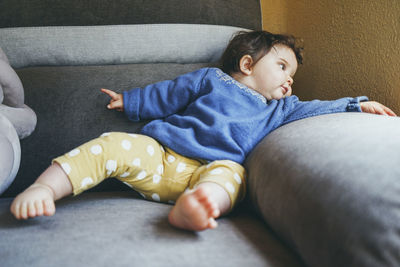 Boy lying on sofa at home