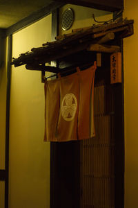 Close-up of clock on table against wall at home