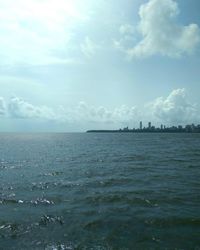 Scenic view of sea and cityscape against sky