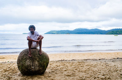 Full length of man on beach against sky