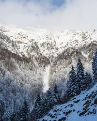 Scenic view of snow covered mountains against sky