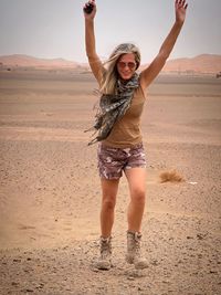 Full length of woman standing at beach