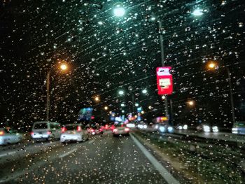 Traffic moving on road in city at night