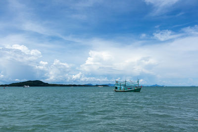 Boat sailing in sea against sky