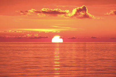 Scenic view of sea against romantic sky at sunset