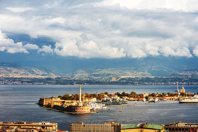 Scenic view of sea and buildings against sky