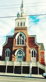 Low angle view of bell tower against sky