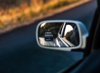 Reflection of car on side-view mirror