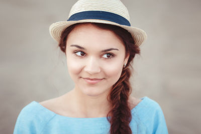 Close-up of woman wearing hat at beach