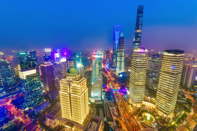 High angle view of illuminated buildings against sky at night