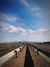 Empty road against sky