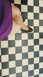 Low section of woman on tiled floor