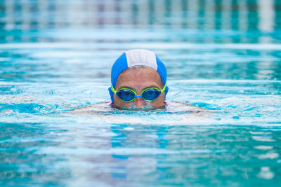 Portrait of man swimming in pool