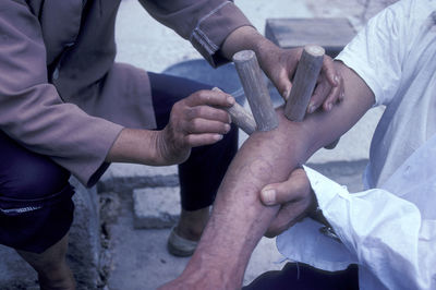 Midsection of man holding hands