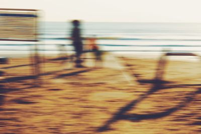 Blurred motion of railing against sea